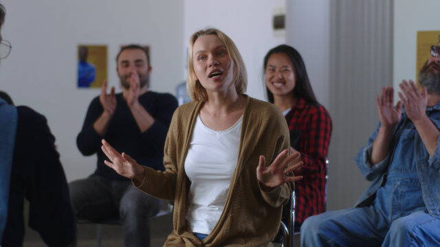 Happy woman telling about overcoming addiction