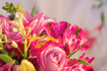 Bridal bouquet with diamond ring placed on the flower petal