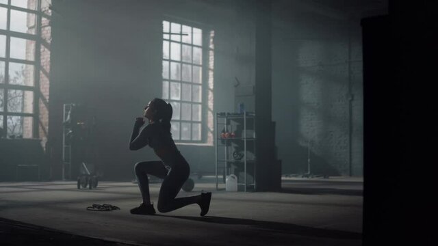Woman doing lunge squat exercise. Bodybuilder making frontal squats with lunges