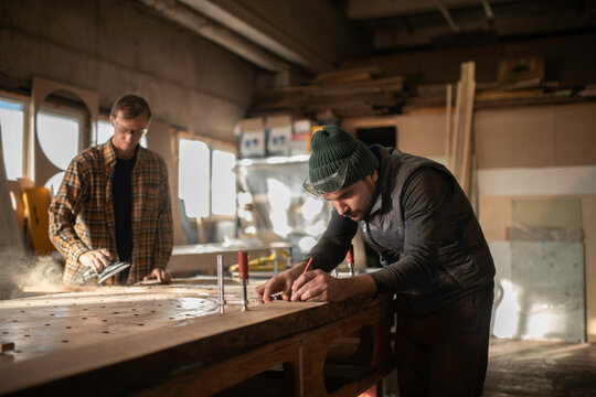 Men working with wood in joinery