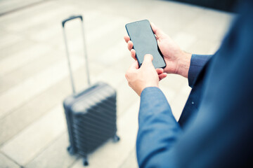 Businessman using smartphone on airport