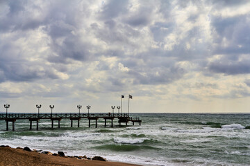 Marbella, Malaga, Spain -23 February 2016.Sand beach and wooden pier on the Costa del Sol, tourist town of Marbella, Spain