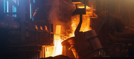 Metallurgical plant. Molten metal pouring from big ladle. Iron cast process. Industrial steel...