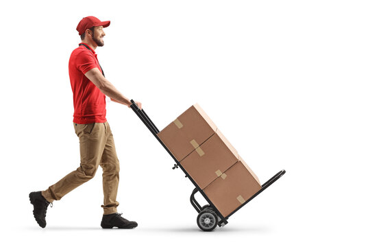 Delivery man pushing a hand truck with cardboard boxes