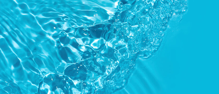 Transparent blue colored clear water surface texture with ripples. Abstract nature background Water waves with copy space