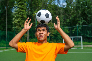 Brazilian soccer player trains and improves soccer ball control by juggling it on his head on sport...