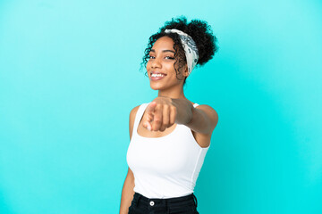 Fototapeta na wymiar Young latin woman isolated on blue background pointing front with happy expression