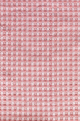 Red white squared fabric texture formed by many columns and rows.