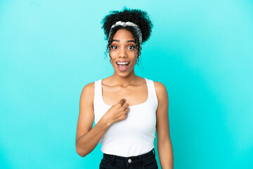 Young latin woman isolated on blue background with surprise facial expression