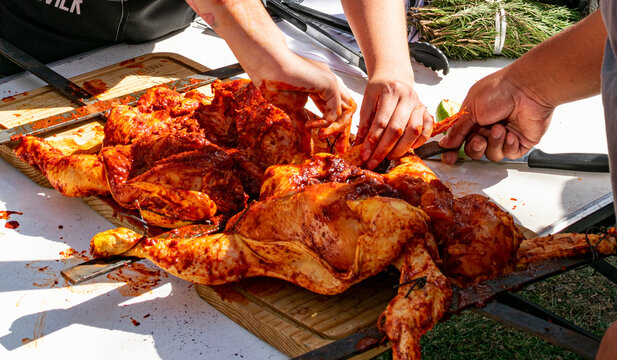 pollo crudo adobado para asar al carb&oacute;n.

manos adobando pollo crudo para asar al carb&oacute;n.    