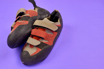 Old climbing shoes, close-up. The concept of a shoe workshop. Torn climbing shoes. The detached...