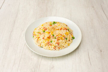 Typical three delicacies Chinese rice dish cooked in a restaurant with gisanstes, chopped scrambled eggs, ham and carrots