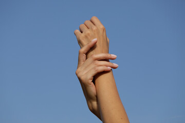 Fototapeta na wymiar woman hands. Sensual woman hand. Sky. 