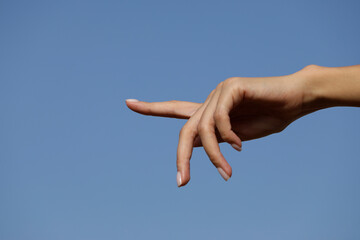 hand on sky background. Finger. Hand woman. Female. 
