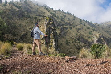 Man watching mountainous landscape on footpath