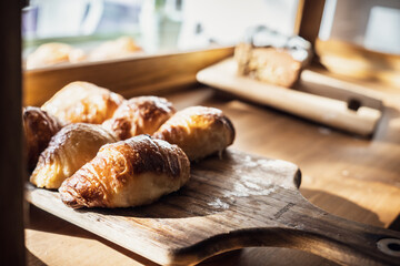 Closeup shot of fresh croissants on a chopping board