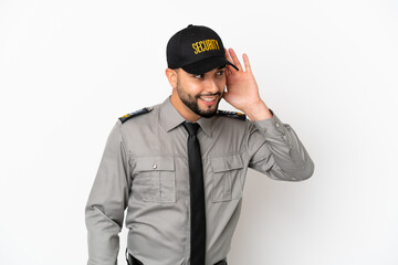 Young arab man isolated on white background listening to something by putting hand on the ear
