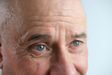 close-up of face old man, senior with deep wrinkles, cheerful gray eyes laugh, concept human emotion, meet old age with dignity