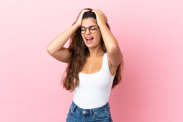 Young caucasian woman isolated on pink background stressed overwhelmed