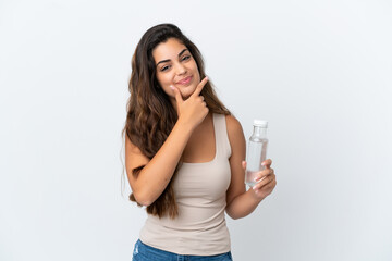 Young caucasian woman with a bottle of water isolated on white background happy and smiling