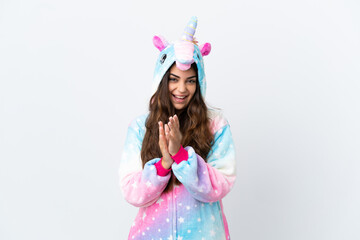 Obraz na płótnie Canvas Young caucasian woman wearing a unicorn pajama isolated on white background applauding after presentation in a conference