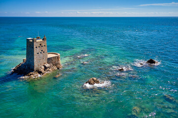 Aerial drone image of Seymour Tower at high tide in the sunshine. Jersey Channel Islands.