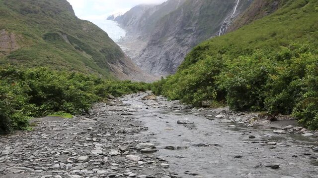 Rocky creek in green glacier valley - Franz Josef Glacier - New Zealand