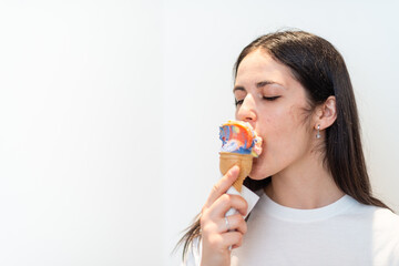 Young Caucasian female engrossed devouring cocktail Ice cream with isolated white background.