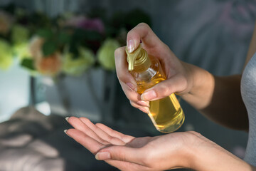 Fototapeta premium Woman's hand apply soap, gel, cream or hand cleansing sanitizer liquid, close up in natural lights. Hygiene and skin care. Infection prevention. Selective focus
