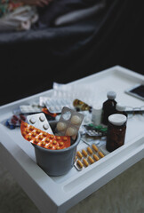 Various drugs and pills on the table at home. Viral pandemic concept. Selective focus