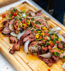 aros de cebolla con tocino a la parrilla  y salsa de mango picado 
montados en tabla de madera 

