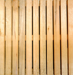 texture of yellowish wooden slats aligned vertically with cracks in full frame