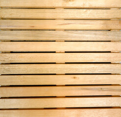 texture of yellowish wooden slats aligned horizontally with cracks in full frame