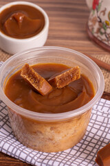 dulce de leche cake on wooden background