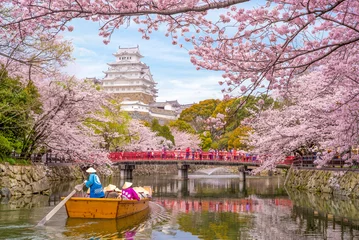 Fotobehang Kyoto boat ride on moat of himeji castle with cherry blossom in japan