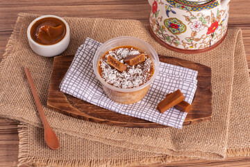 dulce de leche cake on wooden background