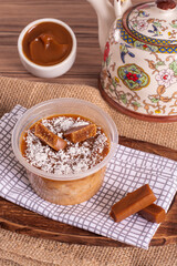 dulce de leche cake on wooden background