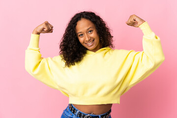 Teenager cuban girl isolated on pink background doing strong gesture