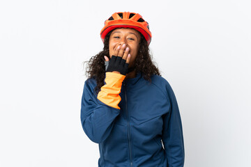 Teenager cyclist woman isolated on white background happy and smiling covering mouth with hand