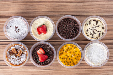 cakes in pot of various flavors on wooden background