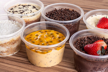 cakes in pot of various flavors on wooden background