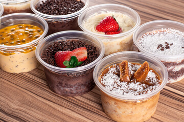 cakes in pot of various flavors on wooden background