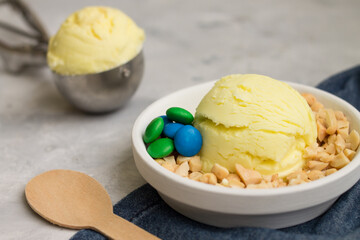 Artisan ice cream on white plate with cloth and gray background.