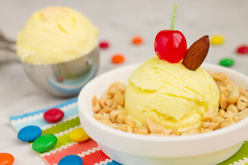 Artisan ice cream on white plate with cloth and gray background.