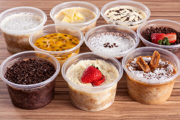 cakes in pot of various flavors on wooden background