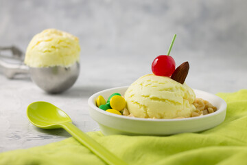 Artisan ice cream on white plate with cloth and gray background.