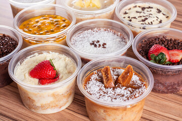 cakes in pot of various flavors on wooden background