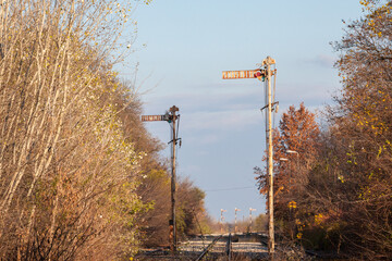 Selective blur on Old sempahore signal and Railway tracks, and rails  in a rural train station in...