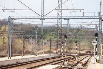 Fototapeta na wymiar Recently reconstructed tracks on the modernized platforms of a suburban train station in a capital city of Europe, with brand new concrete structures and railway signalling in the background...
