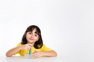 girl in yellow with slime on white background.